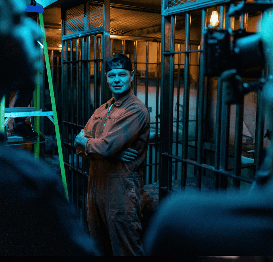 Film crew on set inside a prison cell production