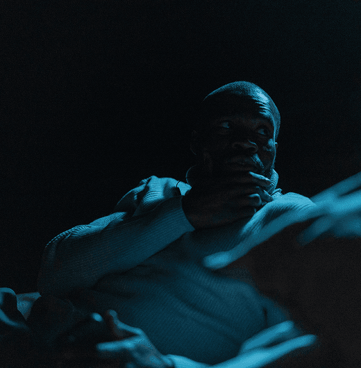 Crew members standing outside a location at night